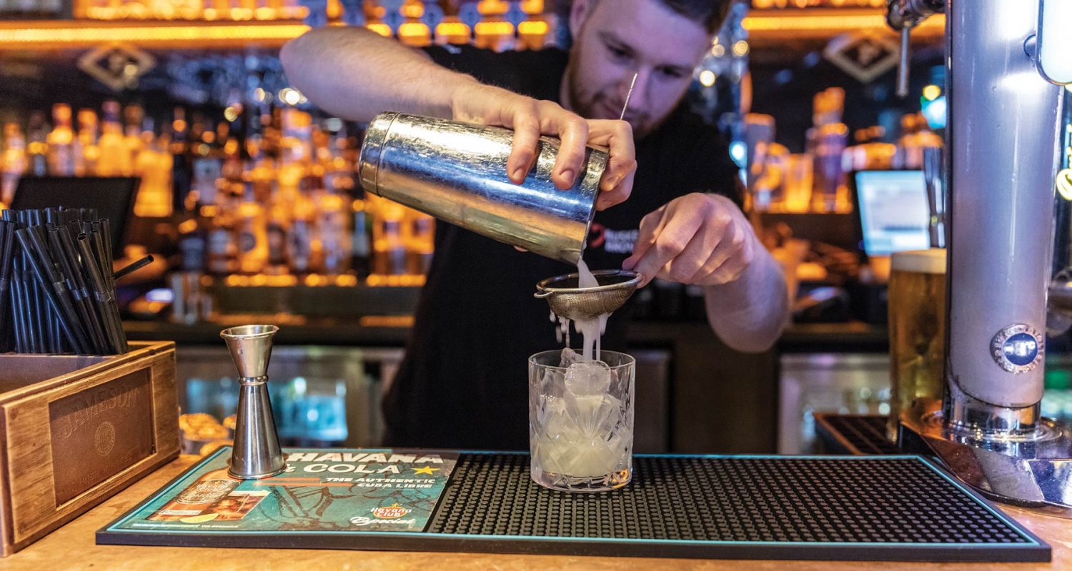 Professional photo of bartender pouring a drink at Crown Square