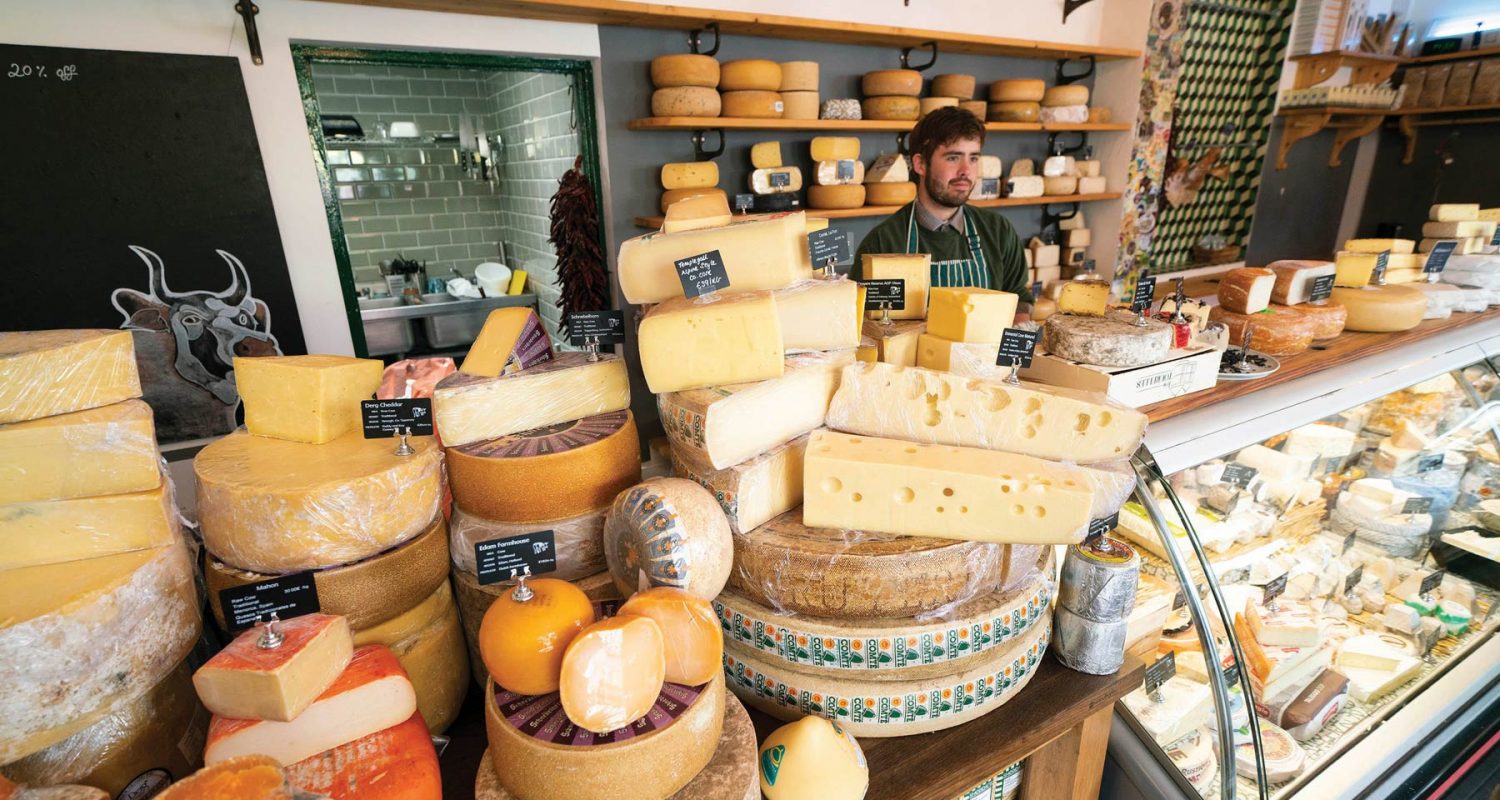 Deli counter in Crown Square displaying assortment of cheeses