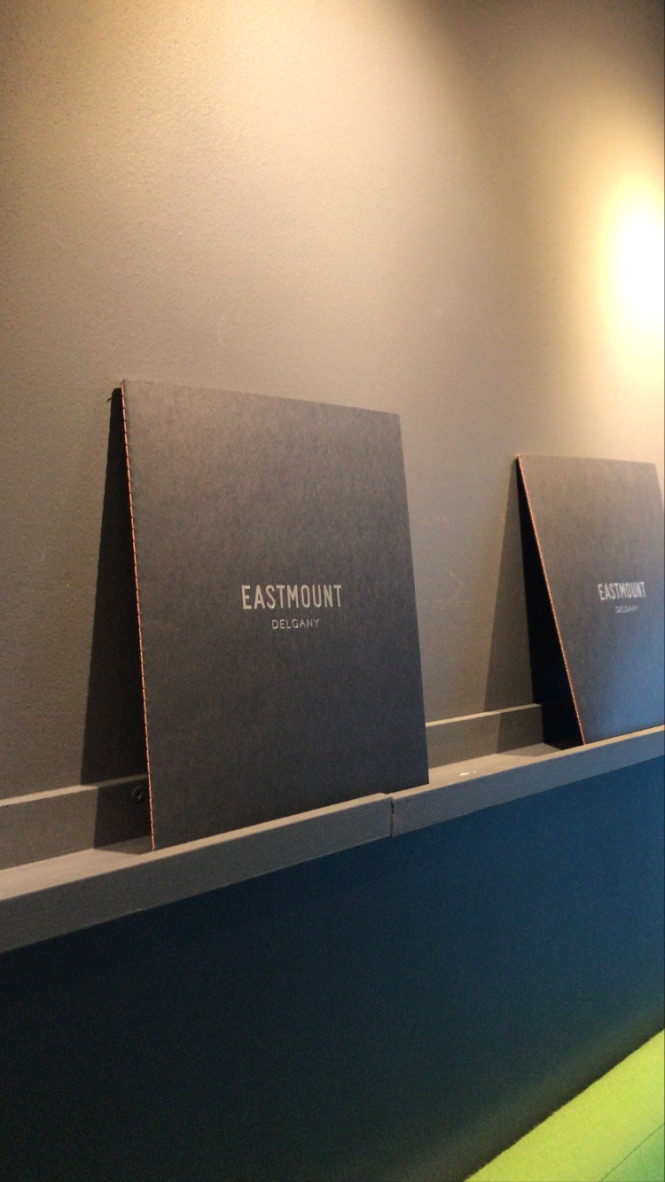 Bound print material on shelf with sleek logo and brand design for Eastmount