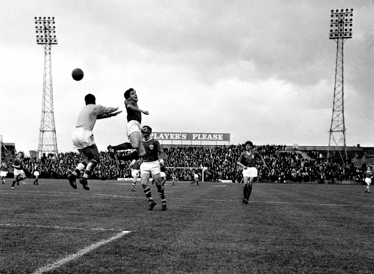 Football players going for a header in an old photograph