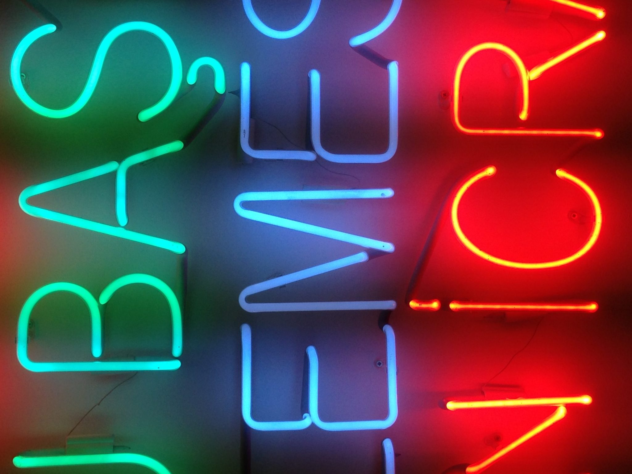 Beautiful photo of neon signs, lettering in green blue and red