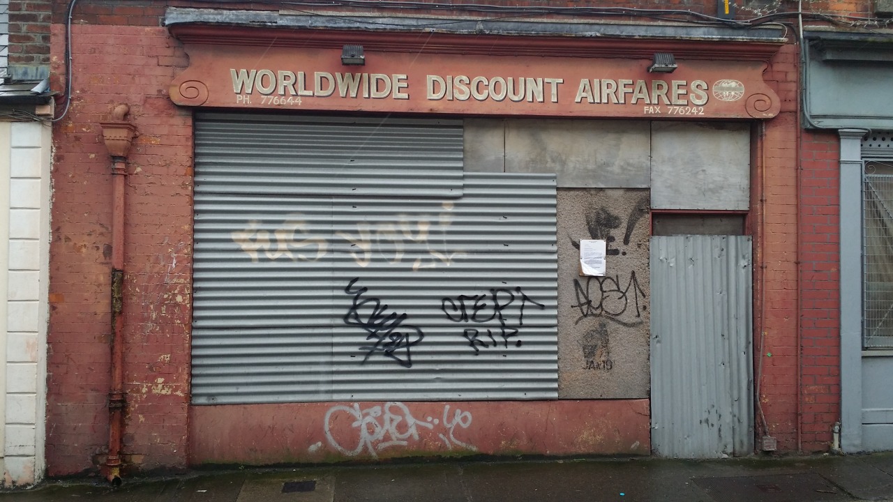 Photograph of urban garage door covered in graffiti