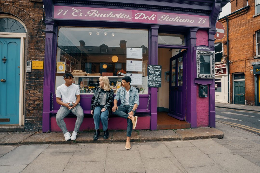 Young people sitting outside of cafe in Dublin, Ireland