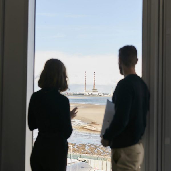 Couple looking out window of Seamark building